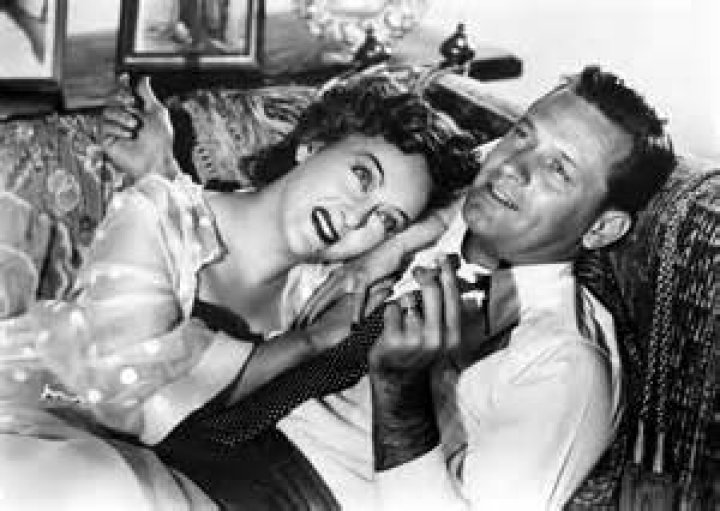 A black and white movie still of Robert Norton and Jill St. John