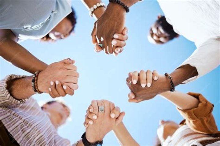a group of people holding glasses of liquid