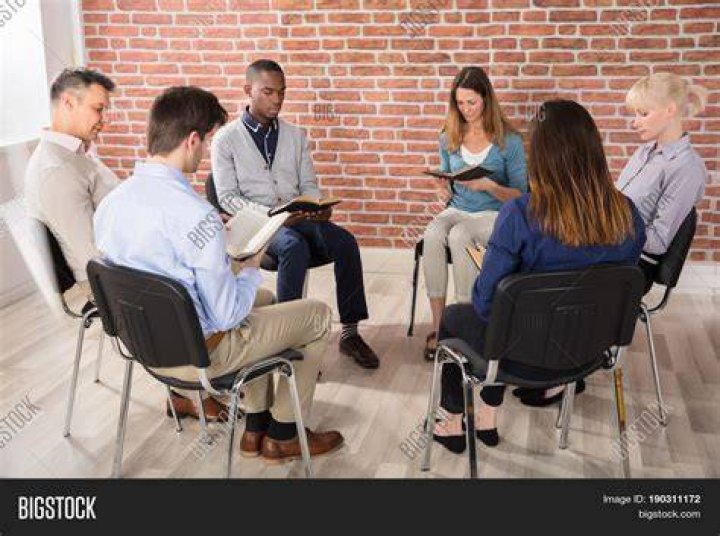 a group of people sitting in chairs a group of people sitting in chairs