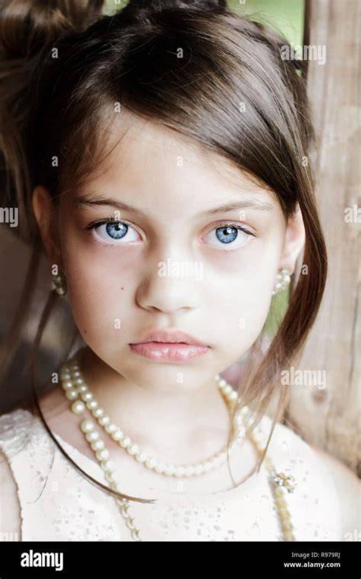 A young girl is pulled in a wagon a young girl is pulled in a wagon