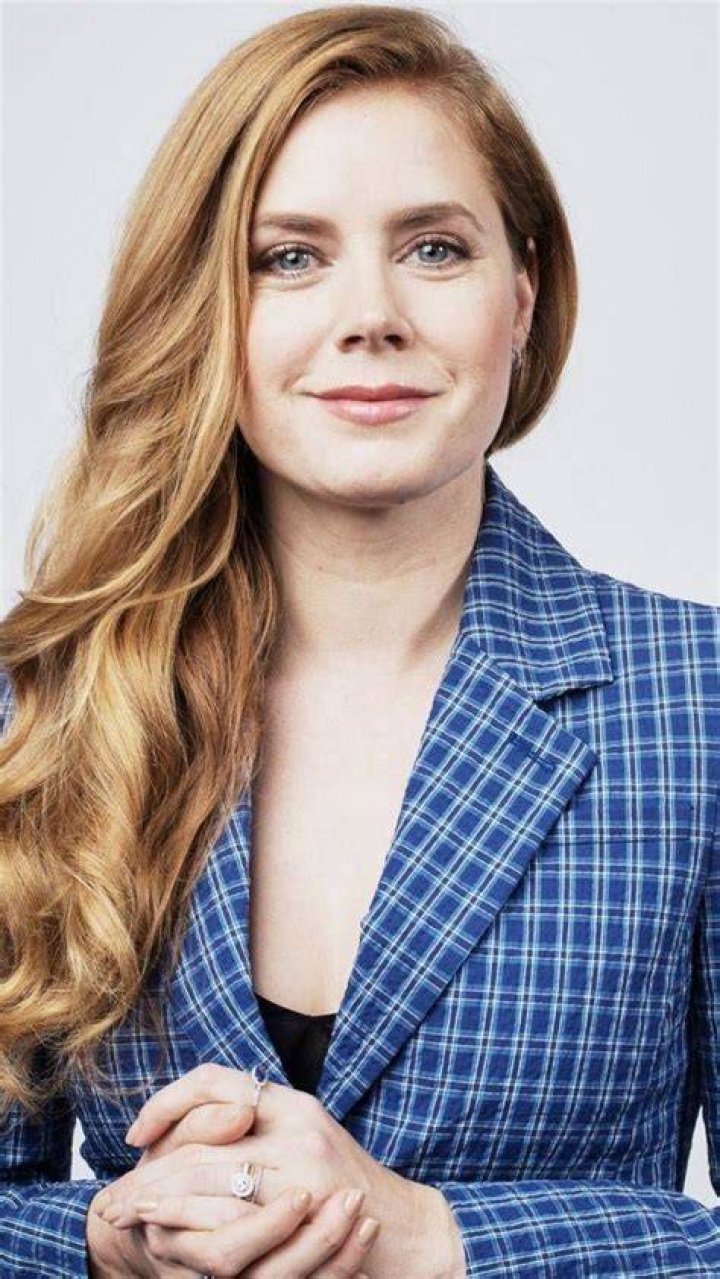 Amy Adams smiling in a black dress.