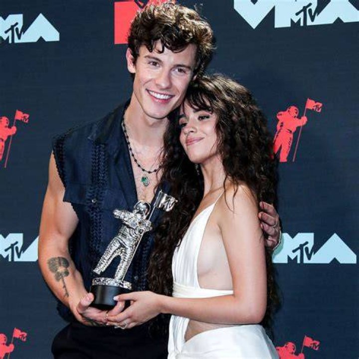 Camila Cabello and Shawn Mendes pose together at an event.