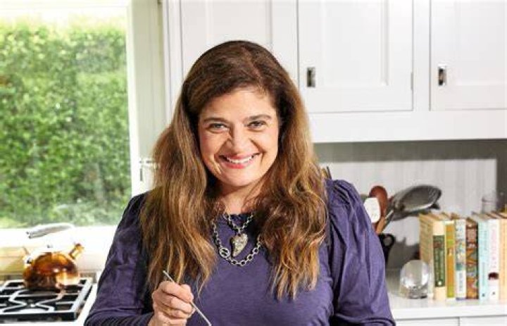 Celebrity chef Alex Guarnaschelli wears a long-sleeved blue blouse in this photograph.