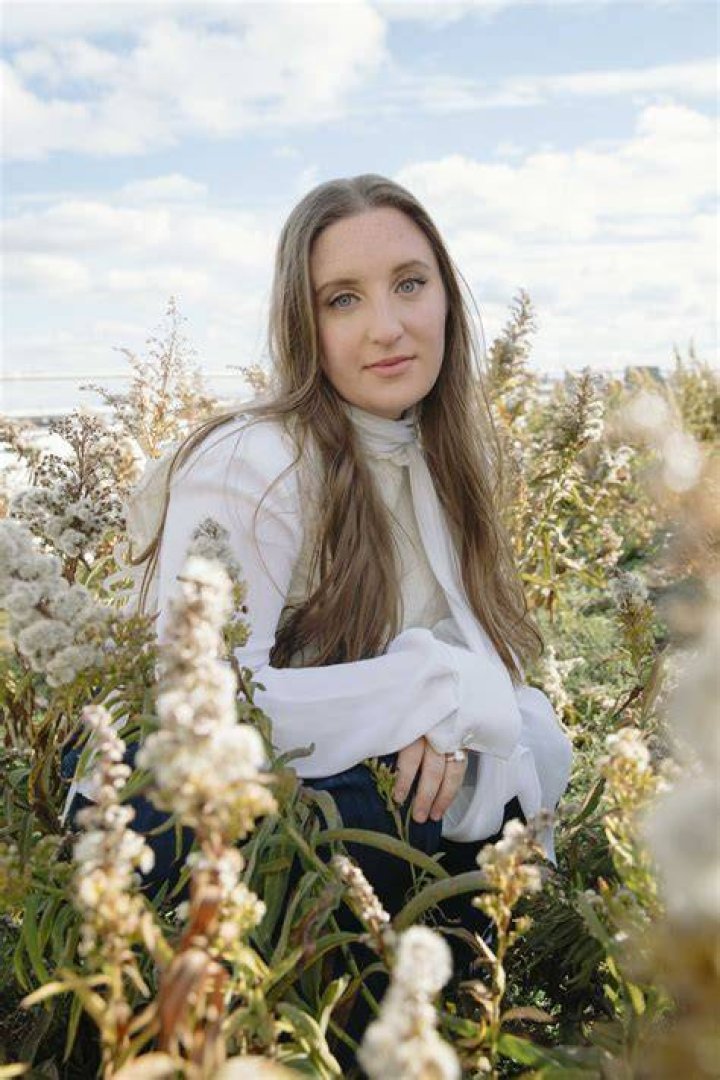 Emma Handler stands amid flowers on a roof emma handler stands amid flowers on a roof