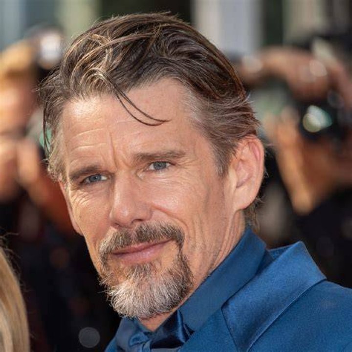 Ethan Hawke posing in a suit.