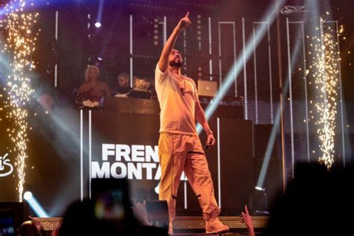 French Montana stands on stage holding a microphone.