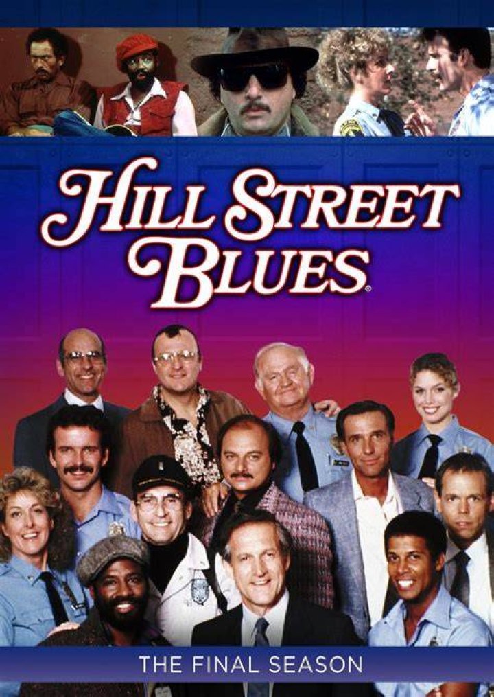Hill Street Blues season 7 cast smiling in front of a backdrop featuring an illustration of a police car