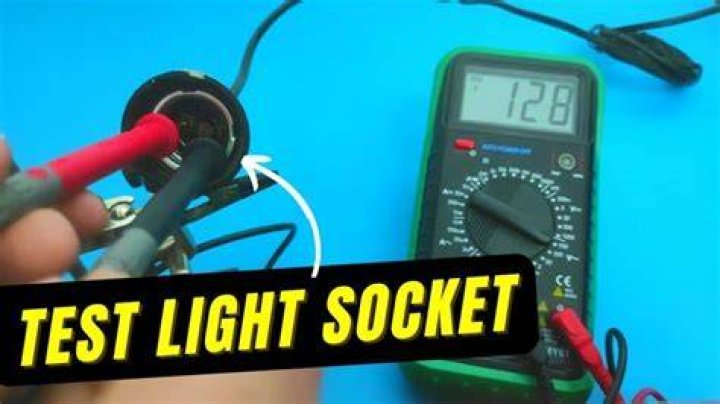 How do you test a light socket with a multimeter?