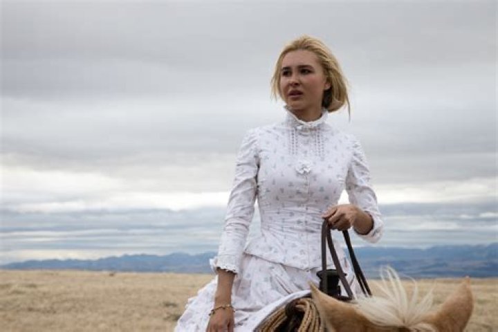 Isabel May as Elsa in a blue dress alone in a field in '1883'