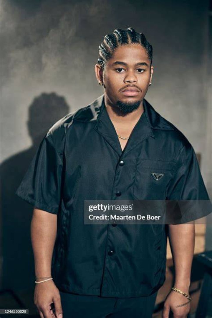 Isaiah John poses for a photo at an event for the FX series 'Snowfall' wearing a white shirt