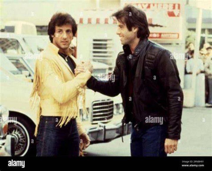 John Travolta and Sylvester Stallone in suits