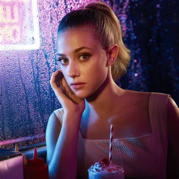 Lili Reinhart as Betty Cooper, KJ Apa as Archie Andrews, and Camila Mendes as Veronica Lodge sip from a milkshake during the 100th episode of Riverdale