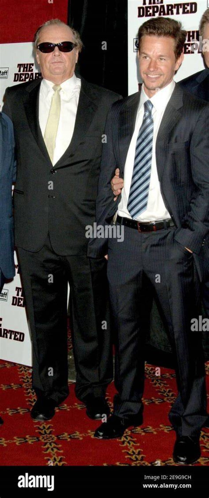 (L-R) Jack Nicholson, Mark Wahlberg, and Leonardo DiCaprio smiling in front of a white background