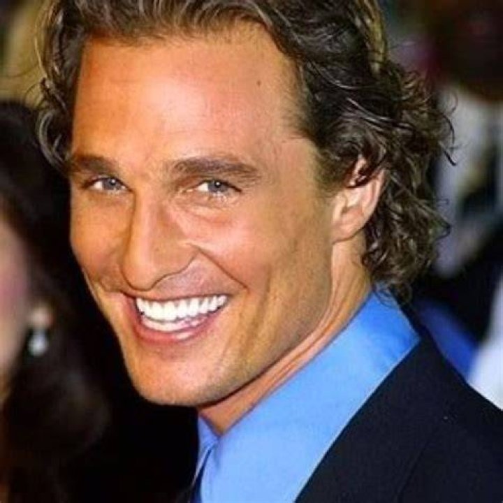 Matthew McConaughey smiles in a blue suit
