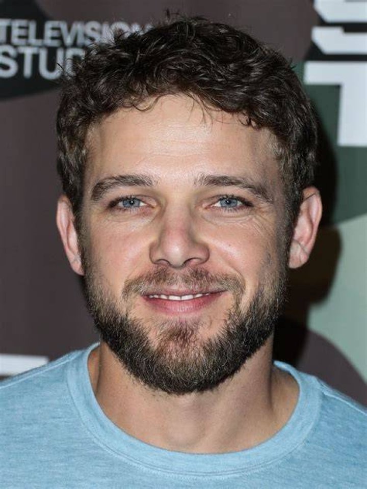 Max Thieriot, wearing a blue button-down shirt with his hands in his pockets, the 'Fire Country' Season 1 finale on CBS