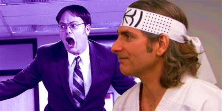 Sensei Billy (Michael Imperioli) ties Dwight's (Rainn Wilson) black belt around his waist in season 9 of 'The Office'