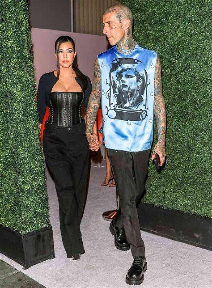 Travis Barker and Kourtney Kardashian smiling with their faces close together