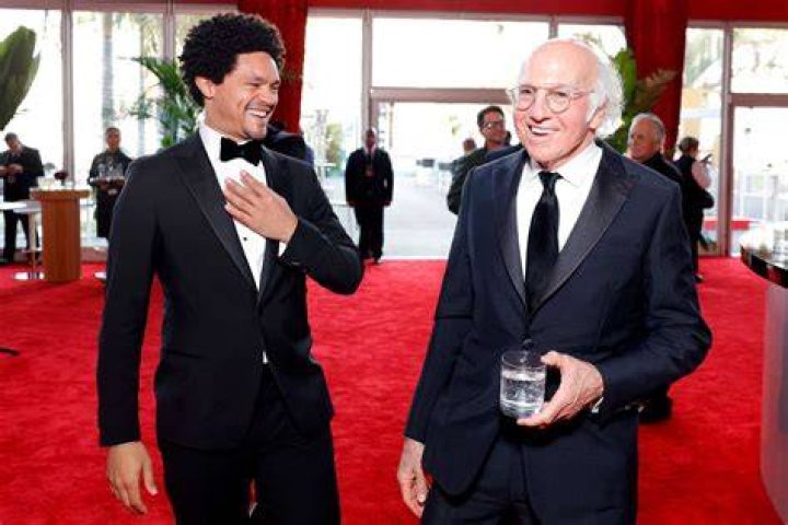 Trevor Noah and Larry David; Ashley Graham and Lindsay Vonn pose together at the 2024 Vanity Fair Oscar Party