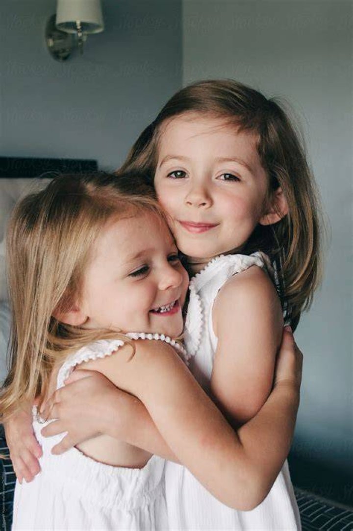 Two young sisters pose for a family photo in London two young sisters pose for a family photo in london