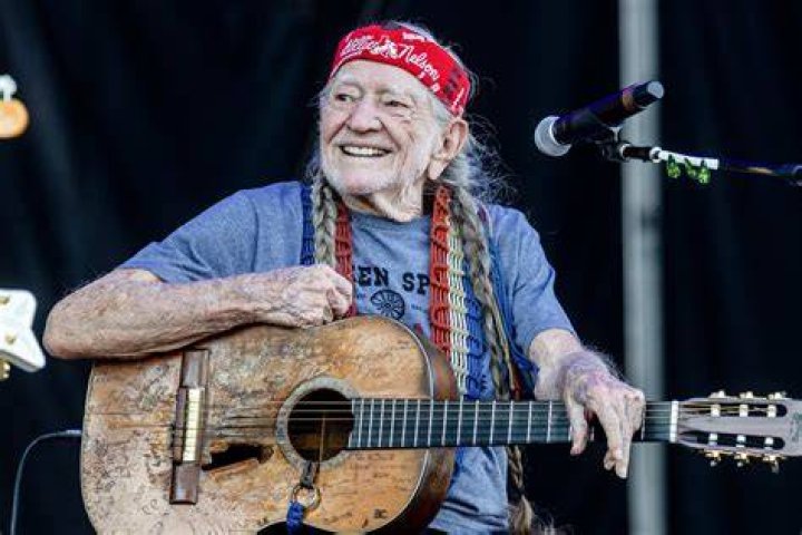 Willie Nelson, pictured playing his guitar, could cause fights without flirting