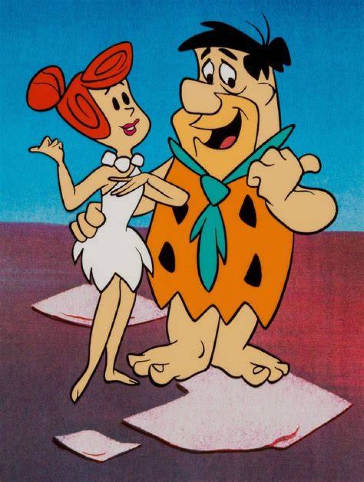 Wilma and Fred from The Flintstones in their house